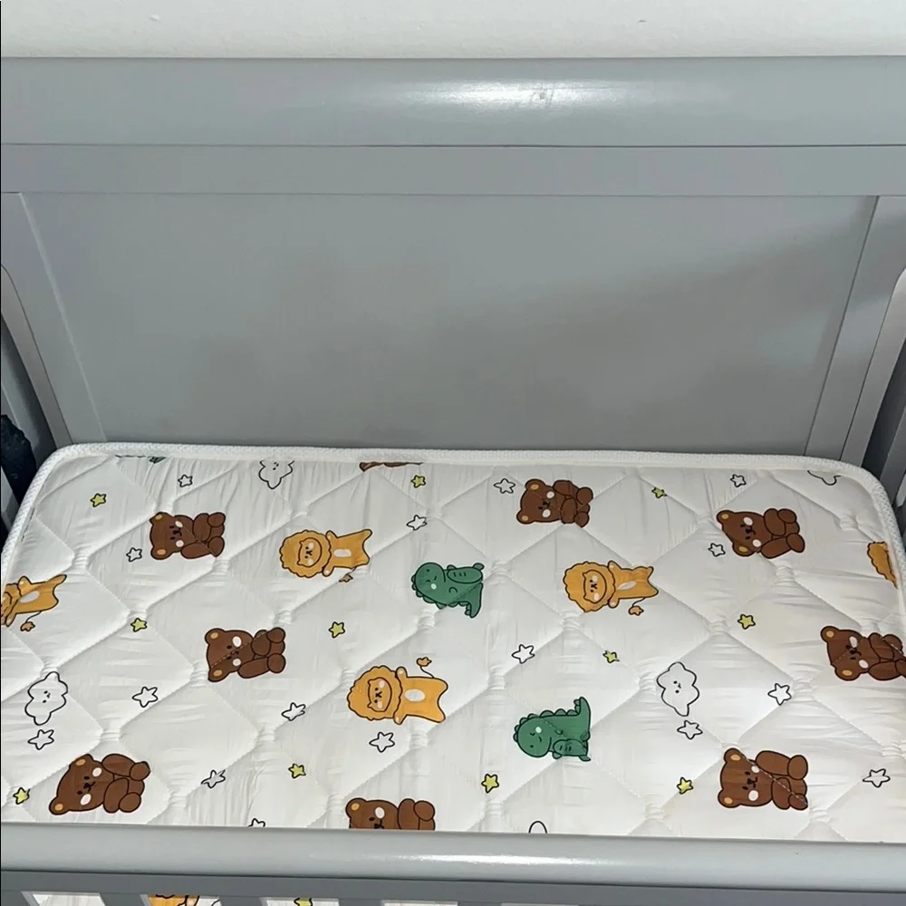 Gray Baby Crib with Printed Mattress